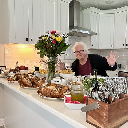Woman near table full of food