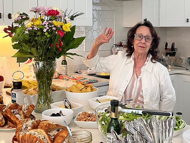 Woman by table with a bouquet of flowers